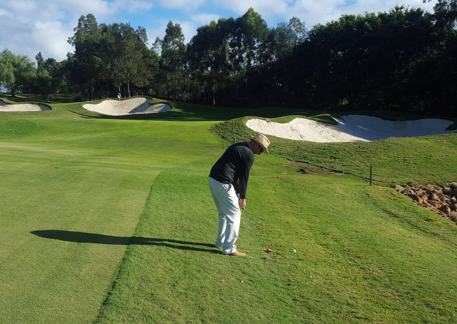 Original phone photo of a golfer chipping below the bunkers in the Hunter Valley