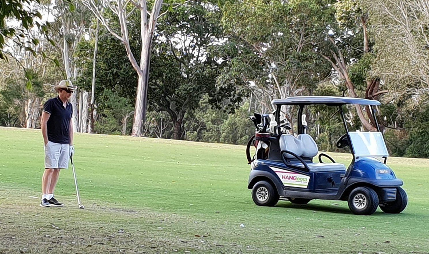 Original photo of a golfer sizing up a putt beside the buggy